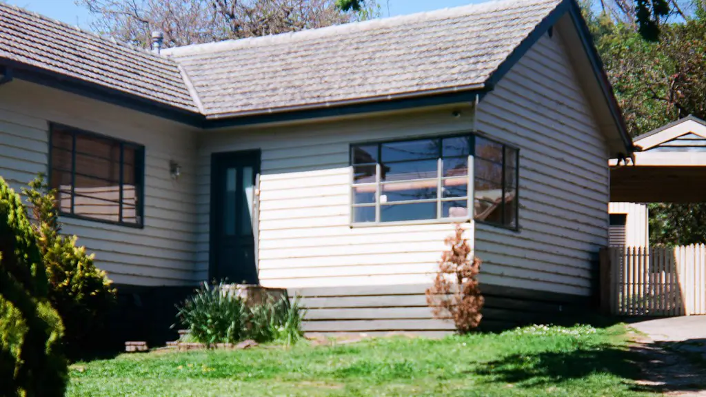 Post-war weatherboard house with a tiled roof and timber-framed windows