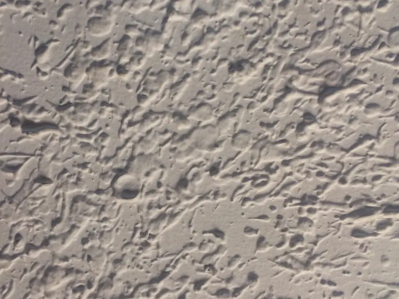 Close-up of a swirled, stippled ceiling texture